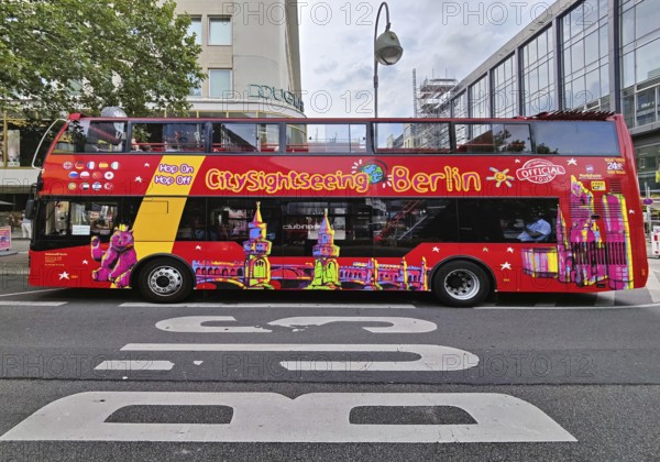 Double-decker bus for the city tour on Tauentzienstraße with Kaiser Wilhelm Memorial Church, Charlottenburg, Berlin, Germany