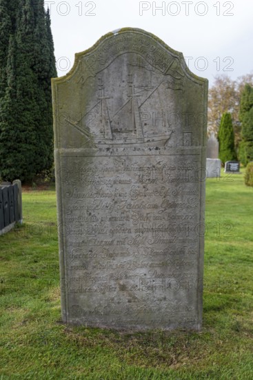Gravestone with ship motif, cemetery of St John's Church, Nieblum, Föhr Island, Schleswig-Holstein, Germany