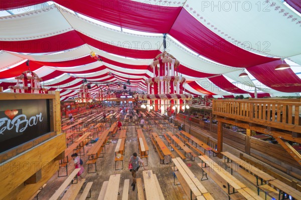 Marquee with red ceilings and wooden benches, bar in the foreground, inviting atmosphere, Cannstatter Wasen folk festival, Sonja Merz marquee, Stuttgart, Germany