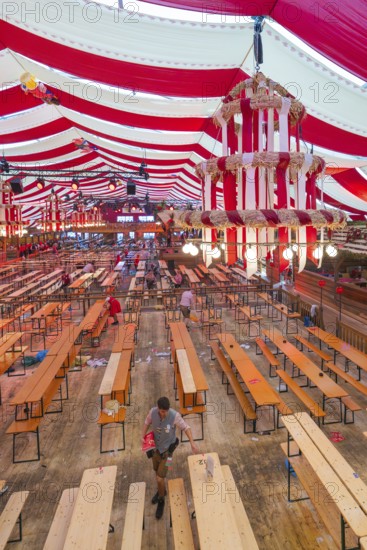 View of a festively decorated beer tent with red blankets and empty wooden benches, Volksfest Cannstatter Wasen, Sonja Merz Festzelt, Stuttgart, Germany