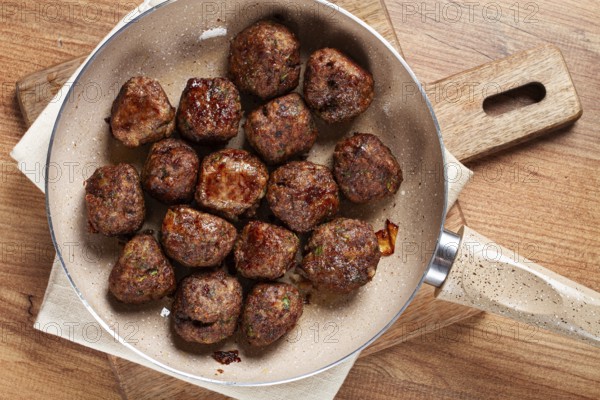 Fried meatballs in a frying pan, homemade, no people