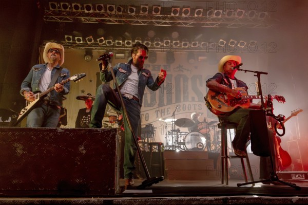 Stefan Bühler (Russ T. Rocket), guitarist, Alec Völkel (Boss Burns) and Sascha Vollmer (Hoss Power), singer of the band The BossHoss on their Back To The Boots Tour 2025 at Capitol Hannover on 3 October 2025