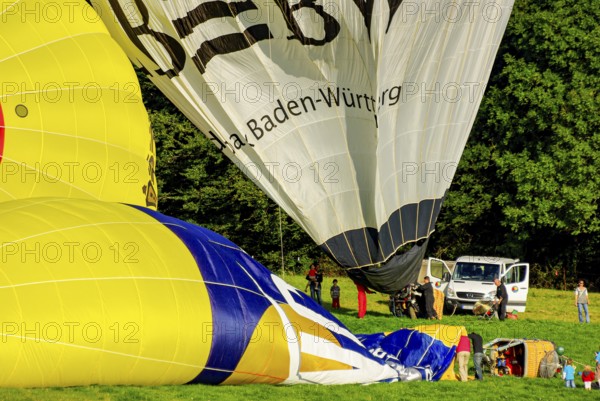 Hot air balloons being prepared for take-off as part of an air show at the Rossfeld in Metzingen-Glems, Baden-Württemberg, Germany, for editorial use only