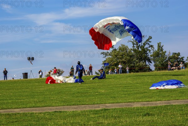 Parachutists have landed after an aerial acrobatic performance during an air show on the Rossfeld in Metzingen-Glems, Baden-Württemberg, Germany, for editorial use only