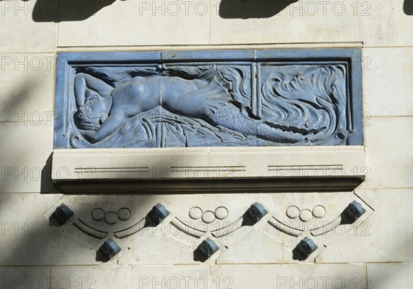 Vichy. A blue relief sculpture is prominently displayed on the wall of a historic building. Thermal spa, the neo-Moorish Centre Thermal des Domes, Allier, Auvergne Rhone Alpes, France