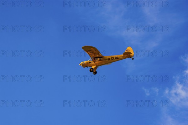 A Piper PA-18 Super Cub of the Bravo Lima Formation during a flight demonstration as part of an air show at the Rossfeld in Metzingen-Glems, Baden-Württemberg, Germany, for editorial use only