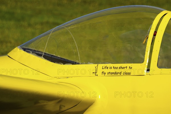 Life is too short to fly standard class, slogan on the canopy frame of a Letov LF-107 Lunak glider during an air show at Rossfeld in Metzingen-Glems, Baden-Württemberg, Germany, for editorial use only