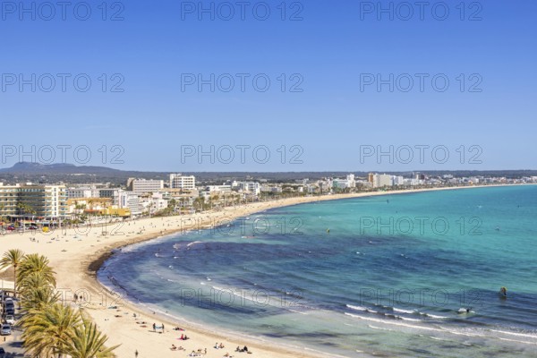 Aerial view at a tourist resort with hotels and tourists on a sand beach at a Mediterranean sea bay, Can Pastilla, Mallorca, Spain