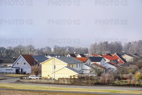 Residential area with detached houses and gardens along streets on a cold winter day, Falköping, Sweden