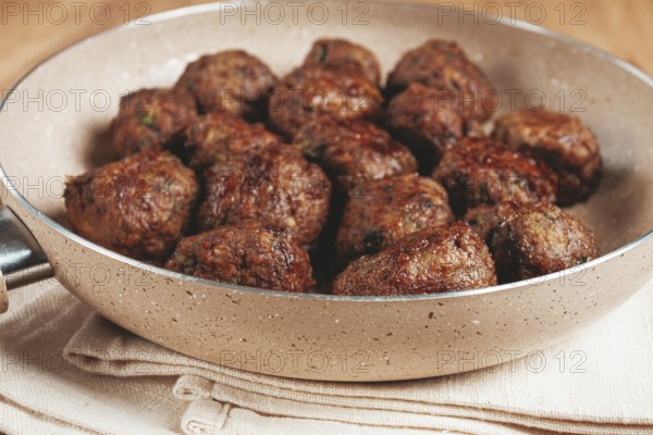 Fried meatballs in a frying pan, homemade, no people