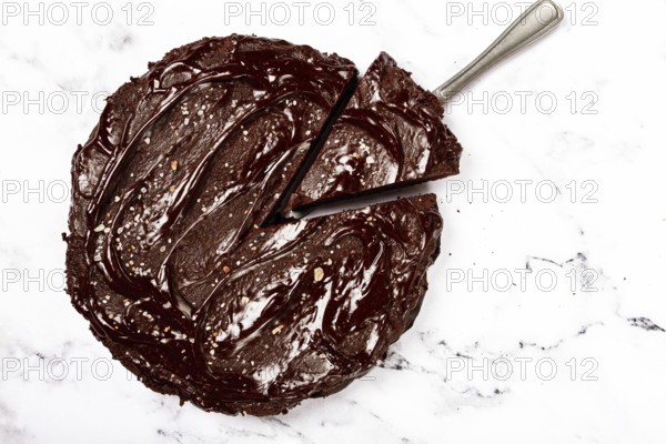 Chocolate cake, round cake, on a marble light table, top view, homemade cakes, no people