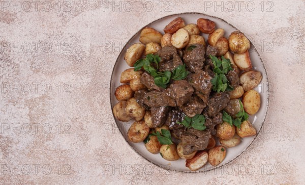 Kuyrdak, roast offal with potatoes and fresh herbs, homemade in Kazakh, no people