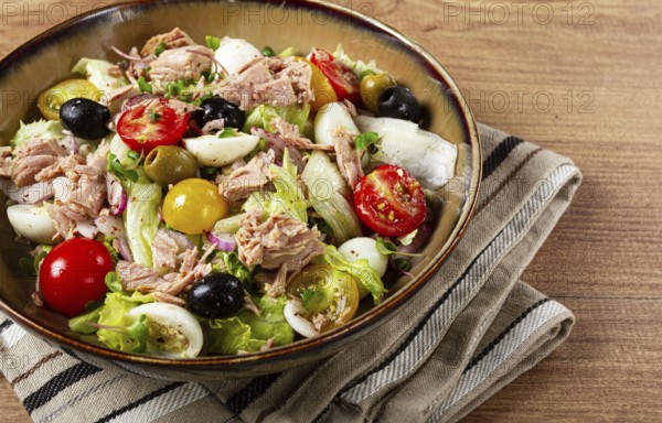 Salad with canned tuna, vegetable salad with quail eggs, lettuce, red onion, cherry tomatoes, olives, keto food, healthy food, homemade, no people