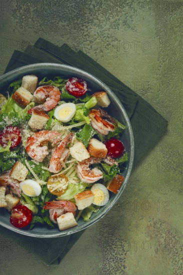 Caesar salad, with tiger prawns, shrimp salad, lettuce, quail eggs, cherry tomatoes, parmesan cheese, no people