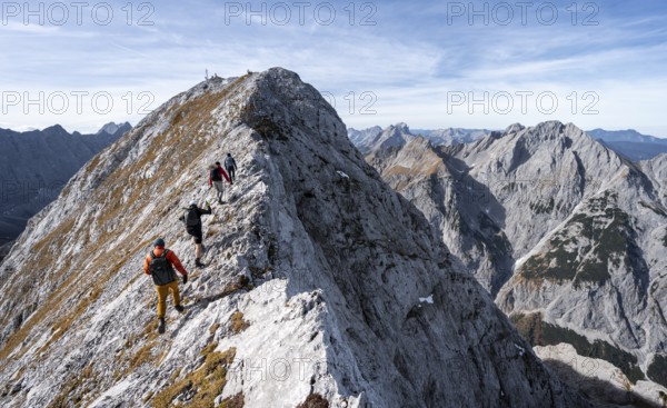 Mountain panorama, group of mountaineers on the ridge of the Gamsjoch, transition to the main summit of the Gamsjoch, western summit with summit cross behind, in autumn, Rißtal in the Eng, Karwendel, Tyrol, Austria
