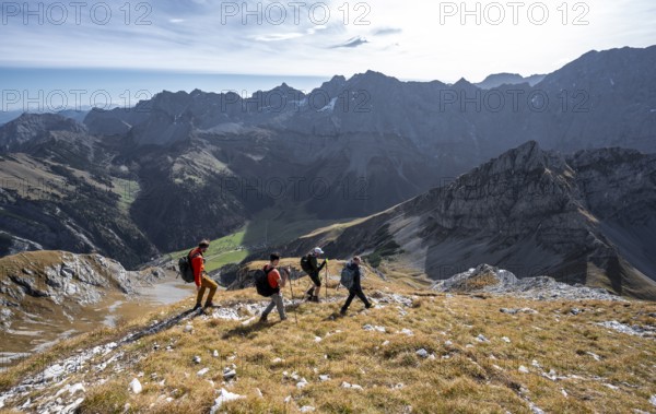 Group of mountaineers descending from the Gamsjoch, in autumn, mountain panorama with Spritzkarspitze and Lamsenspitze, Rißtal in the Eng, Karwendel, Tyrol, Austria