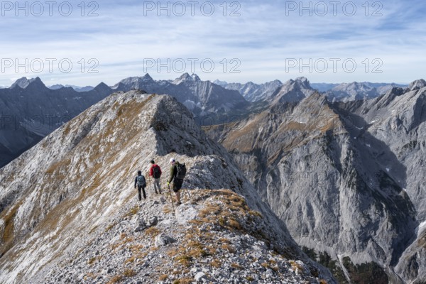 Mountain panorama, group of mountaineers on the ridge of the Gamsjoch, transition to the main summit of the Gamsjoch, behind western summit with summit cross, behind mountain ridge of the Hinterautal-Vomper chain, in autumn, Rißtal in the Eng, Karwendel, Tyrol, Austria