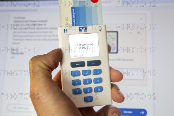 Online banking symbol image: Scanner for online banking in front of a bank website opened on a PC