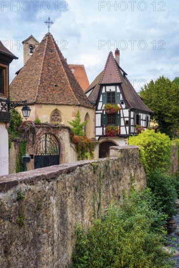 Picturesque Kaysersberg with half-timbered houses on the Weiss river in the old town centre