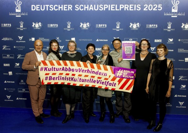 Johannes Heinrichs, Philipp Harpain, Wibke Behrens and others with a poster #KulturAbbauVerhindern and #BerlinIst Kulturellevielfalt on the red carpet in front of the award ceremony at Pullmann Berlin Schweizerhof, Berlin, 09.10.2025