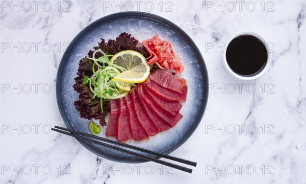 Tuna sashimi, with side dish, on a marble table, homemade, no people