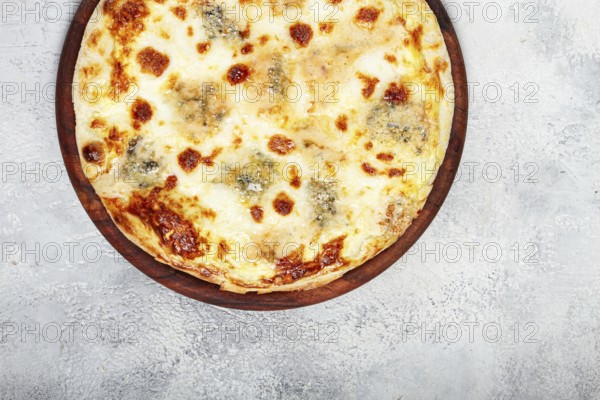 Freshly baked cheese pizza, white pizza, on a wooden plate, homemade, no people