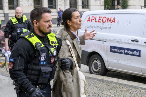 Arrest of a New Generation activist on Pariser Platz after a symbolic house search at the Stiftung Familienunternehmen und Politik, the car in the background reads, among other things: Realising Potential, Berlin, 10.10.2025