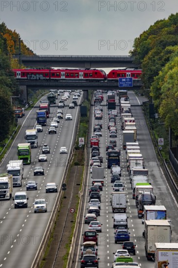 Local train crossing the A3 motorway between the Hilden junction and the Mettmann junction, view to the south, traffic jam due to construction work, North Rhine-Westphalia, Germany