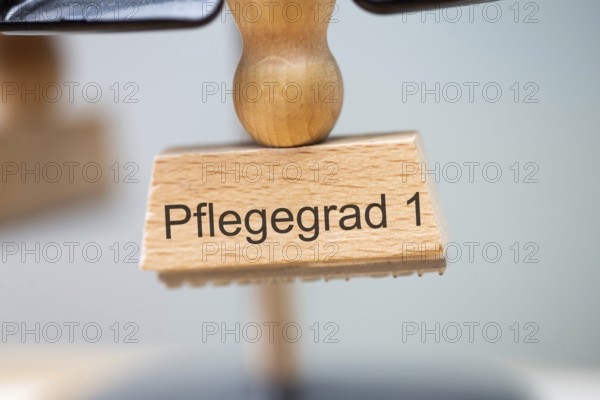 (Photomontage) Close-up of a stamp with the inscription PFLEGEGRAD 1