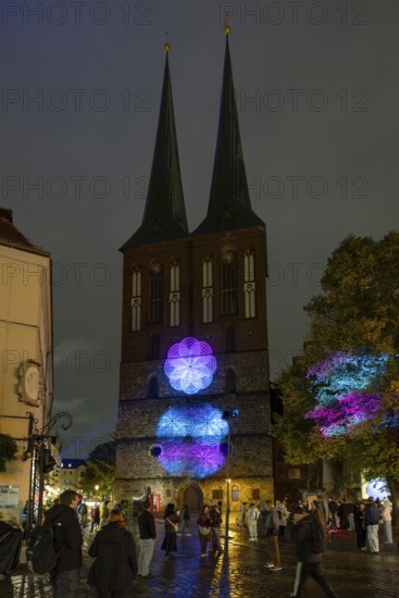 Nikolaikirche in the Nikolaiviertel, 21st BERLIN FESTIVAL OF LIGHTS, motto Let's Shine Together, light installations, 8 October 2025, Berlin, Germany, opening day in drizzle < english> 21st BERLIN FESTIVAL OF LIGHTS, motto Let's Shine Together, light installations, October 8, 2025, Berlin, Germany