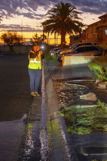 Las Vegas, Nevada - Devyn Choltko, a water waste investigator, patrols a residential neighborhood, recording and issuing tickets for illegal water use. The Las Vegas Valley Water District has cut usage of scarce Colorado River water by more than 30% over the last 20 years despite a growing population