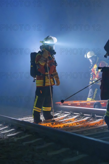 Rescue workers at work on tracks with stretcher and helmet in the dark, fire brigade exercise in the new construction tunnel of the Hermann Hesse railway, Ostelsheim, Calw district, Germany