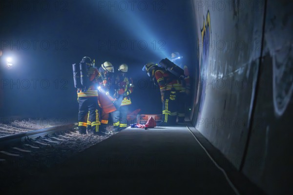 Fire brigade team in the tunnel during an exercise with various utensils, fire brigade exercise in the new construction tunnel of the Hermann Hesse railway, Ostelsheim, Calw district, Germany