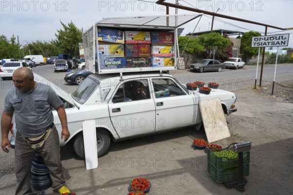 A car as an improvised roadside fruit market stall, selling fruit such as strawberries by the roadside, Tsiatsan, Armavir province, Armenia