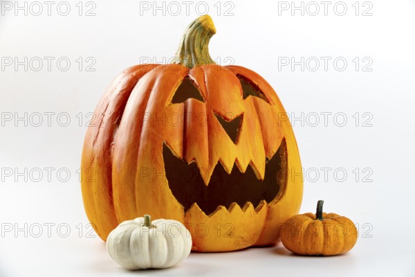 Spooky Halloween decoration with large and two small pumpkins, white background
