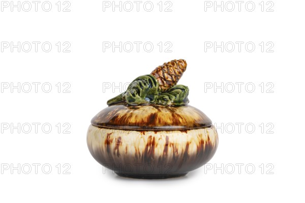 Brown ceramic jar with pine cone decoration on the lid, white background