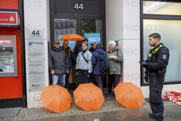 New Generation activists arrested by the police. The New Generation symbolically organises a house search at the CDU Economic Council, a lobby organisation. The action is organised under the hashtag Merzmafia. Berlin, 08.10.2025
