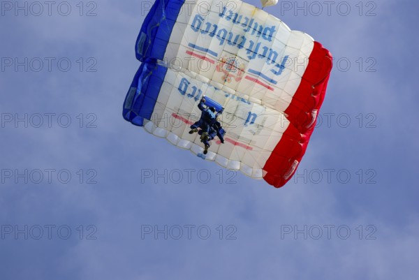 Two parachutists during an aerial acrobatic performance as part of an air show at the Rossfeld in Metzingen-Glems, Baden-Württemberg, Germany, for editorial use only