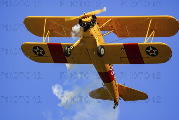 A Boeing-Stearman biplane during a flight demonstration as part of an air show at the Rossfeld in Metzingen-Glems, Baden-Württemberg, Germany, for editorial use only