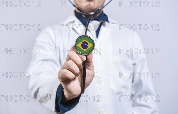 Doctor hands holding stethoscope with Brazil flag. Brazil health and care concept