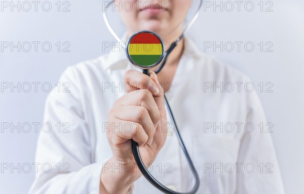 Female doctor holding stethoscope with Bolivia flag. National health system of Bolivia