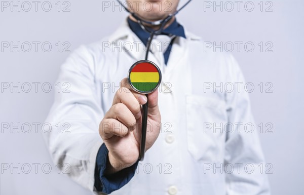 Doctor hands holding stethoscope with Bolivia flag. Bolivia health and care concept