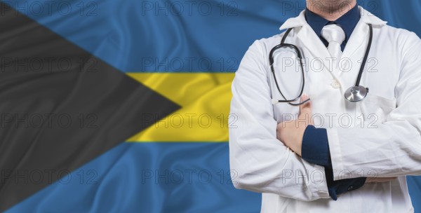 Male doctor with stethoscope on Bahamas flag. Doctor holding stethoscope on Bahamas flag