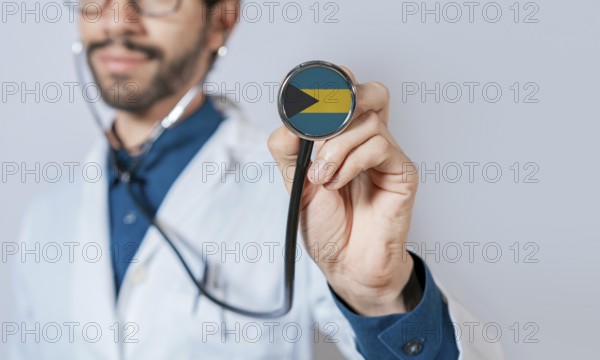 Doctor holding stethoscope with Bahamas flag. Bahamas health and care concept. Bahamas flag on stethoscope