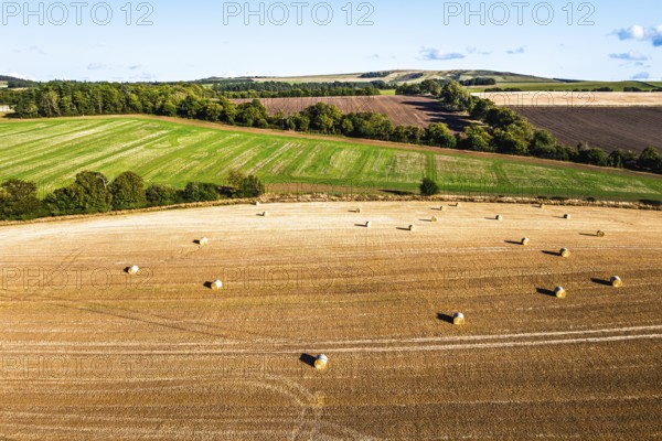 Straw bales in the Scottish fields from a drone, Southeast Scotland, UK