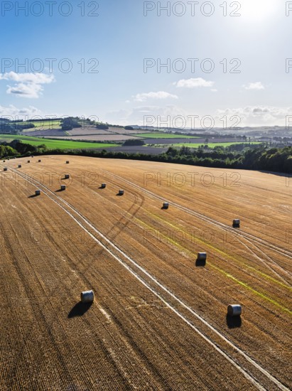 Straw bales in the Scottish fields from a drone, Southeast Scotland, UK
