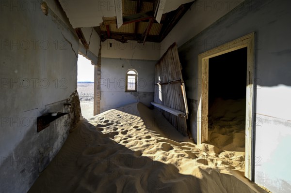 Sand mountains in a former dwelling house, interior photograph, Kolmanskop, restricted diamond area, near Lüderitz, Karas region, Namibia