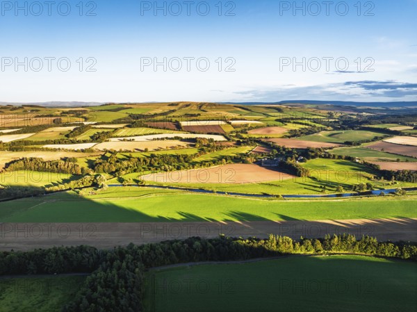 Fields and Farms over River Teviot and Minto Crags from a drone, Roxburghshire, Scottish Borders, Scotland, UK