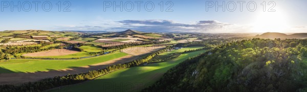 Panorama of evening Fields and Farms over River Teviot and Minto Crags from a drone, Roxburghshire, Scottish Borders, Scotland, UK