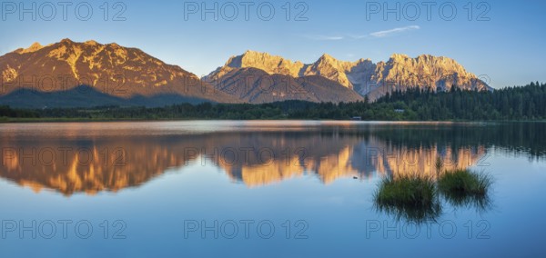 View over the Barmsee to the Karwendel mountains in the evening light, peaks with alpenglow are reflected in the water, Krün near Mittenwald, Upper Bavaria, Bavaria, Germany